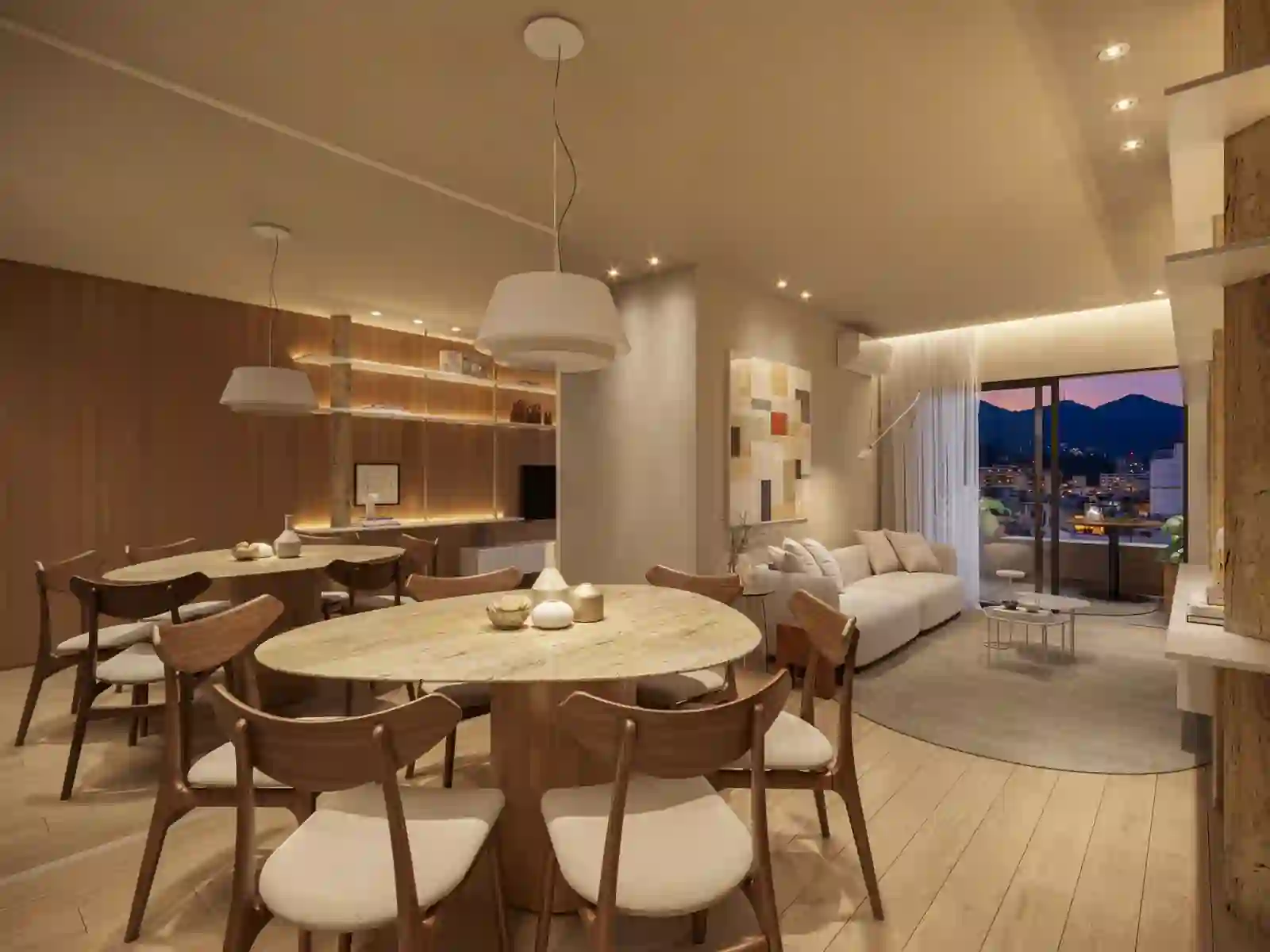 Living e jantar do apartamento decorado Symphony Residences — projeto Studio Roca, com vista para as montanhas do Rio ao entardecer